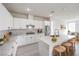 Bright kitchen with stainless steel appliances, white cabinets, and marble countertops and backsplash at 3065 Blue Monaco St, Las Vegas, NV 89117