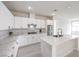 Modern kitchen with white cabinets, marble countertops, and stainless steel appliances at 3065 Blue Monaco St, Las Vegas, NV 89117