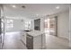 Open kitchen with island, marble countertops, stainless steel appliances, and a fireplace at 3065 Blue Monaco St, Las Vegas, NV 89117