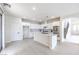 Modern kitchen featuring an island, white cabinets, double oven and stone countertops at 3065 Blue Monaco St, Las Vegas, NV 89117