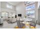 Bright living room with soaring ceilings, large windows, comfortable seating, and a dining area at 3065 Blue Monaco St, Las Vegas, NV 89117