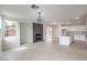 Open-concept area with a kitchen, a modern fireplace and plenty of sunlight at 3065 Blue Monaco St, Las Vegas, NV 89117