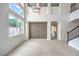 Bright, open living room with wood floors, large windows, and access to the kitchen at 3065 Blue Monaco St, Las Vegas, NV 89117