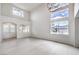Bright living room with high ceilings, large windows, and a double-door entryway at 3065 Blue Monaco St, Las Vegas, NV 89117