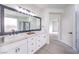 Sleek primary bathroom featuring double sinks with marble countertops and modern fixtures at 3065 Blue Monaco St, Las Vegas, NV 89117