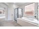 A luxurious main bathroom includes a soaking tub, separate glass shower, and a serene outdoor view at 3065 Blue Monaco St, Las Vegas, NV 89117