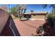 Large backyard features desert landscaping and a covered patio, providing ample space for outdoor living at 3219 Bluebird St, Las Vegas, NV 89121
