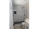 Sleek updated bathroom with stylish shower, contrasting fixtures, and marble-look tile at 3219 Bluebird St, Las Vegas, NV 89121