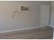 The bedroom is light and bright with wood-look floors, neutral paint, and AC unit at 3219 Bluebird St, Las Vegas, NV 89121