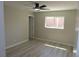 This bedroom has a modern ceiling fan, sleek wood floors, and ample natural light at 3219 Bluebird St, Las Vegas, NV 89121