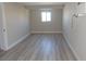 Cozy bedroom features contemporary flooring, neutral walls, and a bright window that allows ample natural light at 3219 Bluebird St, Las Vegas, NV 89121