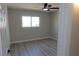 Serene bedroom with modern ceiling fan, light grey walls and window offering natural light at 3219 Bluebird St, Las Vegas, NV 89121