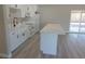 Modern kitchen with white cabinets, a farmhouse sink, island and stainless steel appliances at 3219 Bluebird St, Las Vegas, NV 89121