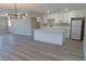 Open floor plan showcasing the kitchen and living room with modern lighting at 3219 Bluebird St, Las Vegas, NV 89121