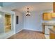 Dining area featuring chandelier, wood flooring, and open access to the bathroom and kitchen at 3318 N Decatur Blvd # 2110, Las Vegas, NV 89130