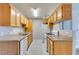 Well-lit kitchen featuring wood cabinetry, marble-look tile flooring and a gas stove at 3318 N Decatur Blvd # 2110, Las Vegas, NV 89130