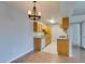 Compact kitchen featuring wooden cabinets, tile floors, and essential appliances at 3318 N Decatur Blvd # 2110, Las Vegas, NV 89130