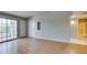 Open-concept living room with wood floors, leads to the bathroom and balcony at 3318 N Decatur Blvd # 2110, Las Vegas, NV 89130