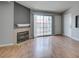 Living room with fireplace, sliding door access to the balcony, and wood-look flooring at 3318 N Decatur Blvd # 2110, Las Vegas, NV 89130