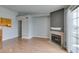 Open-concept living room features wood floors, fireplace, and sliding glass doors at 3318 N Decatur Blvd # 2110, Las Vegas, NV 89130
