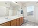 Bright bathroom with double vanity, large mirror, and shower-tub combination at 3515 Cactus Shadow St # 104, Las Vegas, NV 89129