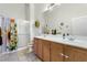 Well-lit bathroom with double sinks, a mirror, and a shower at 3515 Cactus Shadow St # 104, Las Vegas, NV 89129