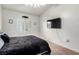 Bedroom with natural light, wall-mounted TV, and a cozy bed at 3515 Cactus Shadow St # 104, Las Vegas, NV 89129