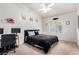 Bright bedroom features a ceiling fan, carpet flooring, and a dedicated workspace at 3515 Cactus Shadow St # 104, Las Vegas, NV 89129