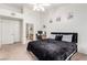 Comfortable bedroom with a vaulted ceiling, work area, and ensuite bathroom access at 3515 Cactus Shadow St # 104, Las Vegas, NV 89129