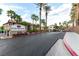 Community entrance with palm trees and landscaping, showcasing the 'Cliff Shadows' community at 3515 Cactus Shadow St # 104, Las Vegas, NV 89129