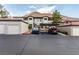 Condominium exterior featuring parking, garages, and nearby mountain views, showcasing a desert community lifestyle at 3515 Cactus Shadow St # 104, Las Vegas, NV 89129