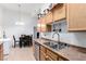 Cozy kitchen with light brown cabinets, stainless steel appliances, and tile flooring at 3515 Cactus Shadow St # 104, Las Vegas, NV 89129