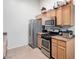 Kitchen featuring stainless steel appliances and tile flooring at 3515 Cactus Shadow St # 104, Las Vegas, NV 89129