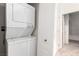 Efficient laundry room with stacked washer and dryer and ample storage space at 3515 Cactus Shadow St # 104, Las Vegas, NV 89129