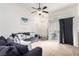 Cozy living room featuring neutral carpet and a ceiling fan for added comfort at 3515 Cactus Shadow St # 104, Las Vegas, NV 89129