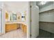 Primary bathroom with dual sinks, and a door leading to a walk-in closet at 3581 Mallard Ave, Pahrump, NV 89048