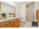 Bathroom features wooden cabinets, tile countertops, shower, staged decor at 3581 Mallard Ave, Pahrump, NV 89048