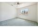 Bright bedroom with neutral carpet, ceiling fan, and a large window offering plenty of natural light at 3581 Mallard Ave, Pahrump, NV 89048