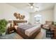 Cozy staged bedroom featuring a bed, seating area, and decorative wall art at 3581 Mallard Ave, Pahrump, NV 89048