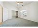 A bedroom with a window, new carpet, ceiling fan, and mirrored closet doors at 3581 Mallard Ave, Pahrump, NV 89048
