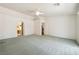 Spacious primary bedroom features neutral carpet, a ceiling fan, and two entry doors at 3581 Mallard Ave, Pahrump, NV 89048