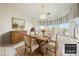 A staged dining room featuring light and neutral colored furniture at 3581 Mallard Ave, Pahrump, NV 89048