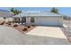 Charming single-story home featuring a well-manicured yard, circular driveway, and attached garage at 3581 Mallard Ave, Pahrump, NV 89048