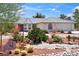 Landscaped front yard with desert plants, rock details, and a charming tile-roofed home at 3581 Mallard Ave, Pahrump, NV 89048