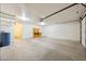 Spacious garage offering ample storage and parking with a garage door and bright lighting at 3581 Mallard Ave, Pahrump, NV 89048