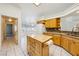 Bright kitchen features wood cabinets and a convenient center island at 3581 Mallard Ave, Pahrump, NV 89048
