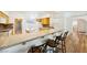 Kitchen view with breakfast bar, decorative backsplash, and ample cabinet space at 3581 Mallard Ave, Pahrump, NV 89048
