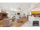 Bright living room featuring hardwood flooring, a stone fireplace, and a breakfast bar at 3581 Mallard Ave, Pahrump, NV 89048