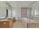 Modern bathroom featuring a soaking tub, double sink vanity, and glass enclosed shower at 3726 Las Vegas Blvd # 1902, Las Vegas, NV 89158