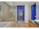 Contemporary bathroom with city views, featuring a soaking tub and glass enclosed shower at 3726 Las Vegas Blvd # 1902, Las Vegas, NV 89158